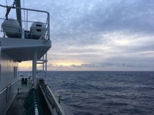 View of the sun setting in clouds. Taken from Scotia deck