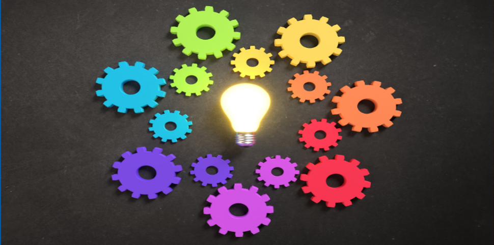 Lightbulb surrounded by multicolour cogs