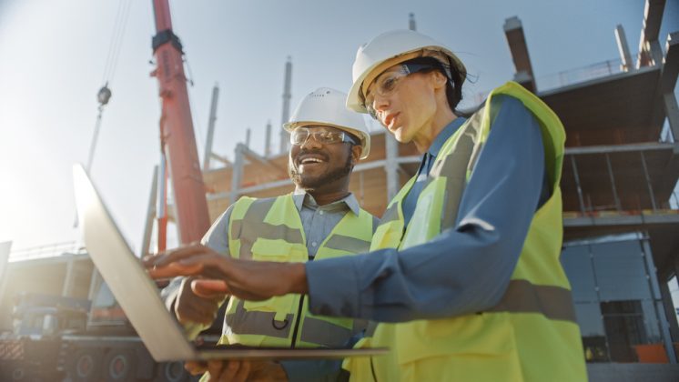 Two construction workers. Shutterstock - Gorodenkoff